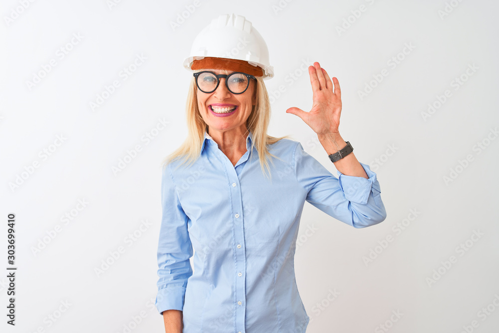 Middle age architect woman wearing glasses and helmet over isolated white background showing and pointing up with fingers number five while smiling confident and happy.