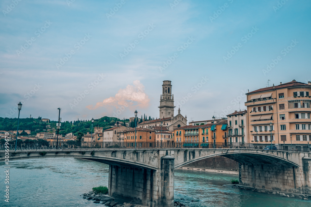 Ponte Garibaldi bridge voer Adige river with Verona Church in the background in Verona, Italy