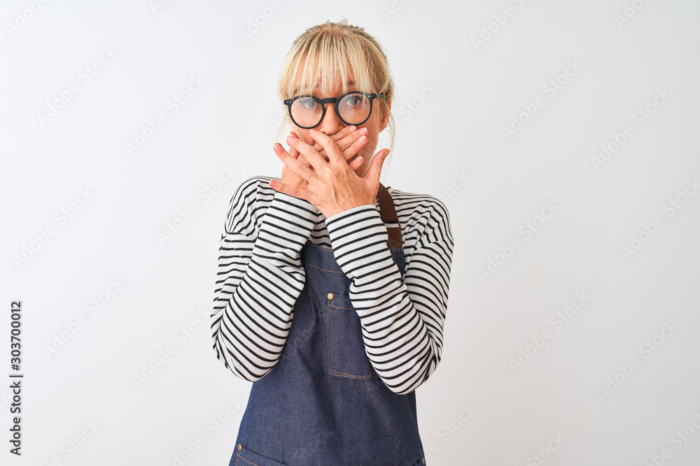 Middle age chef woman wearing apron and glasses over isolated white background shocked covering mouth with hands for mistake. Secret concept. Middle age chef woman wearing apron and glasses over isolated white background shocked covering mouth with hands for mistake. Secret concept.