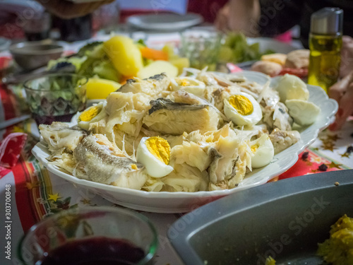 codfish with mashed potatos, spinach and eggs on white plate. Traditional portuguese crhistmas night food