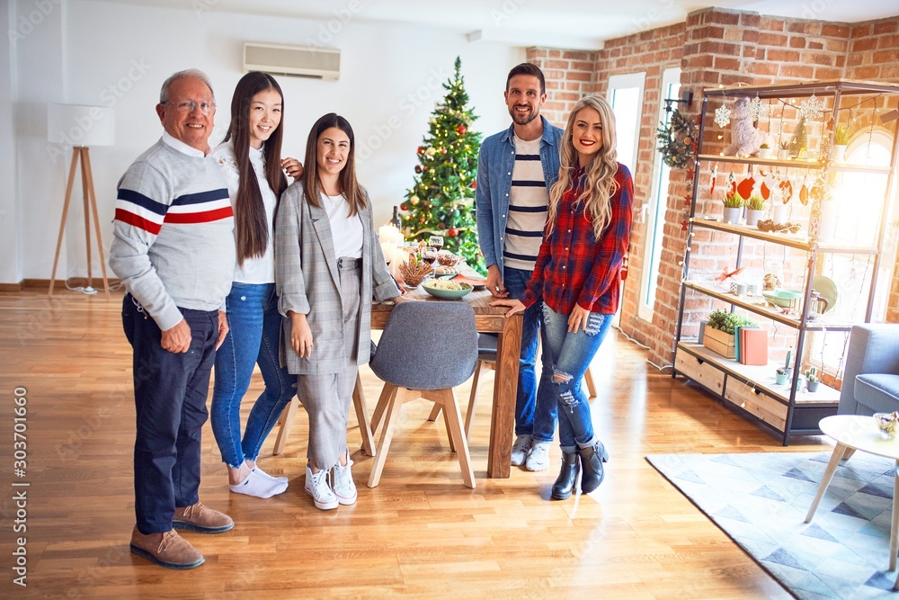 Beautiful family smiling happy and confident. Standing posing with tree celebrating Christmas at home
