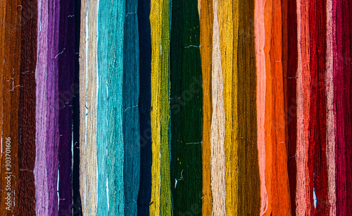 Fényképezés Colorful rainbow of freshly hand dyed yarn hanging on a wall