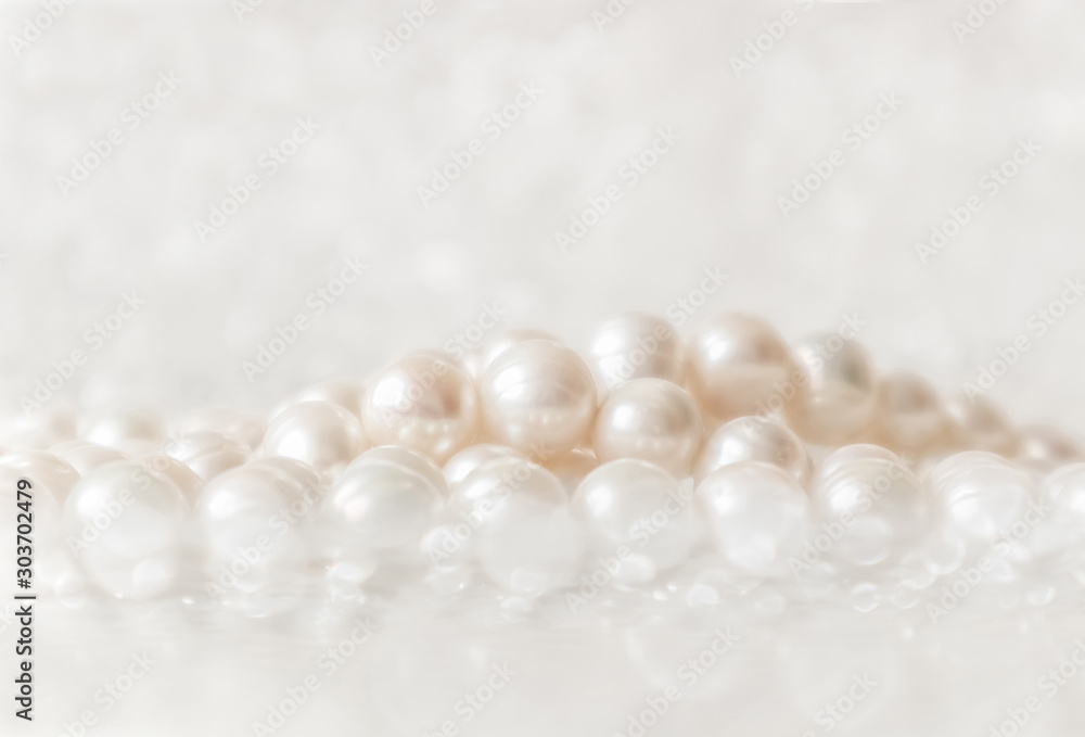 Nature white string of pearls on a sparkling background in soft focus, with highlights Nature white string of pearls on a sparkling background in soft focus, with highlights