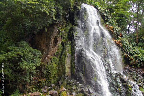 Impressing waterfall in the green nature of Azores islands