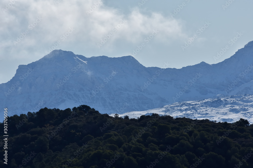 View of the Sierra Nevada with rising clouds, one autumn morning after the snowfall of the night