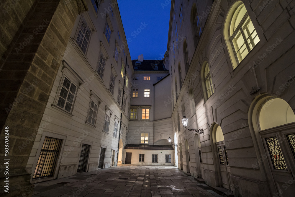 Narrow and dark medieval courtyard in the schweizerhof aisle of the Hofburg palace in Vienna, the former imperial castle residence of the Habsburg dynasty in the Austro Hungarian Empire