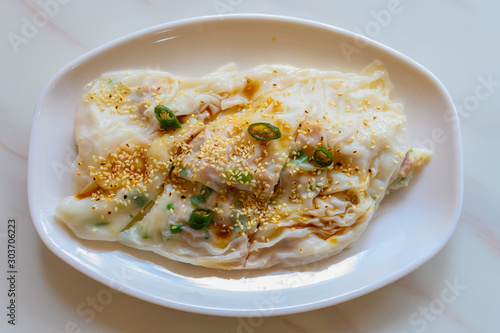 top view traditonal Cantonese food of cheong fun or rice noodle rolls with soy sauce