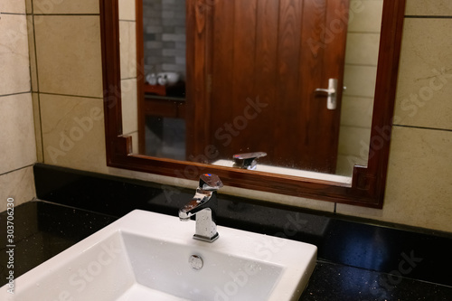 Slika na platnu bathroom with white washbasin with chrome faucet in a hotel room