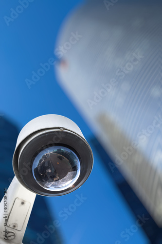 CCTV camera concept with business buildings in the background