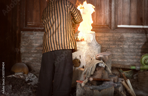 Blacksmith heat up the molten metal to make keris