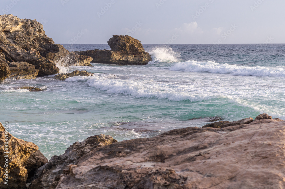 Caribbean sea coast with rocks and hello breaking Caribbean sea coast with rocks and hello breaking