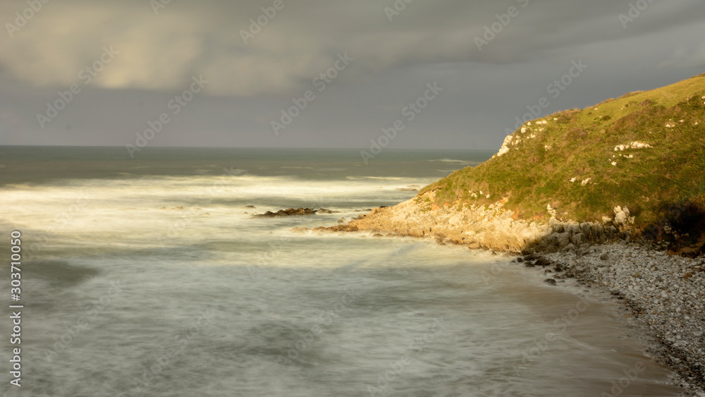 Waves beating against the rocks at Vidiago beach in Asturias
