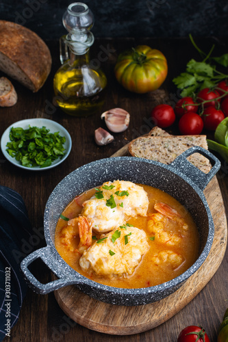 Mediterranean catalan cuisine ingredients, shrimps, raw monkfish, tomatoes, garlic, almonds, olive oil top view