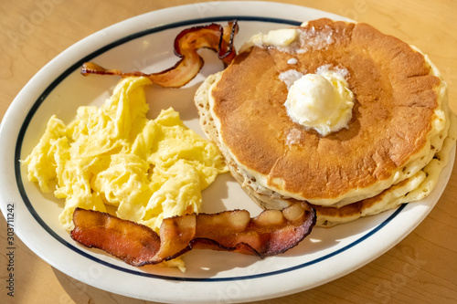 Scramble eggs, hot cakes and bacon photo