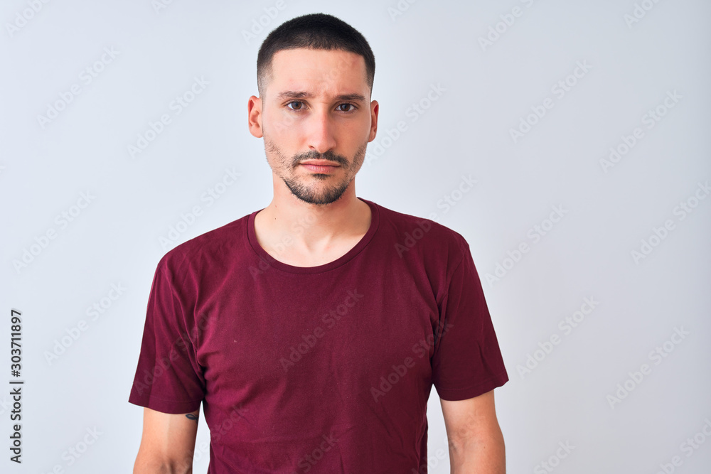 Young handsome man standing over isolated background skeptic and nervous, frowning upset because of problem. Negative person. Young handsome man standing over isolated background skeptic and nervous, frowning upset because of problem. Negative person.