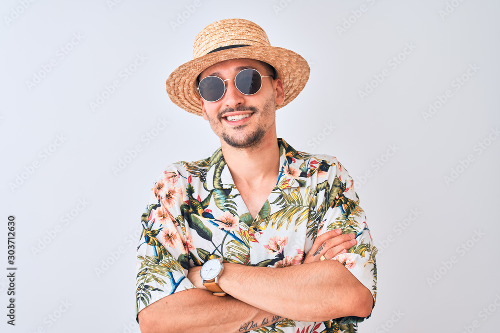 Φωτογραφία Young handsome man wearing Hawaiian shirt and summer hat over isolated background happy face smiling with crossed arms looking at the camera