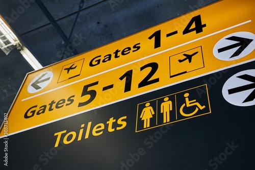 Toilets and gate signs in an airport terminal