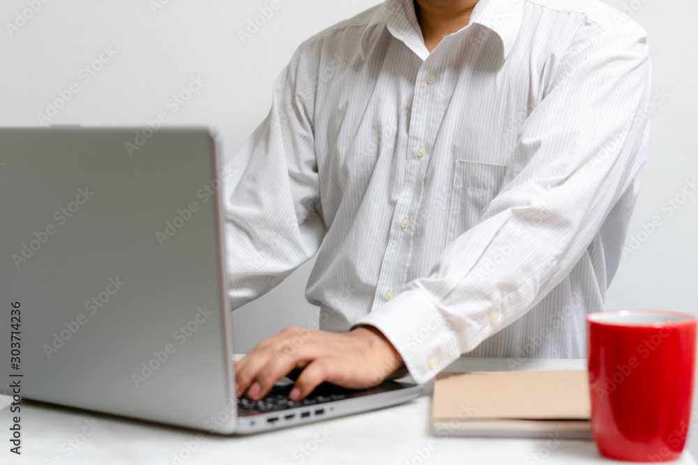 Businessman working at home office with laptop and documents on his desk, start-up business concept. Businessman working at home office with laptop and documents on his desk, start-up business concept.