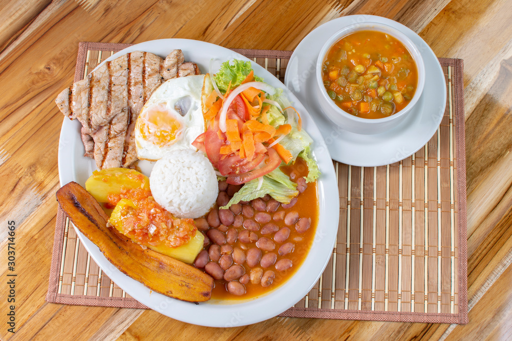 typical Colombian food, meat, egg, rice, avocado, potatoes and vegetables typical Colombian food, meat, egg, rice, avocado, potatoes and vegetables
