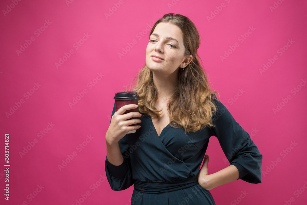 Glamor woman with a drink of coffee on a pink background Glamor woman with a drink of coffee on a pink background