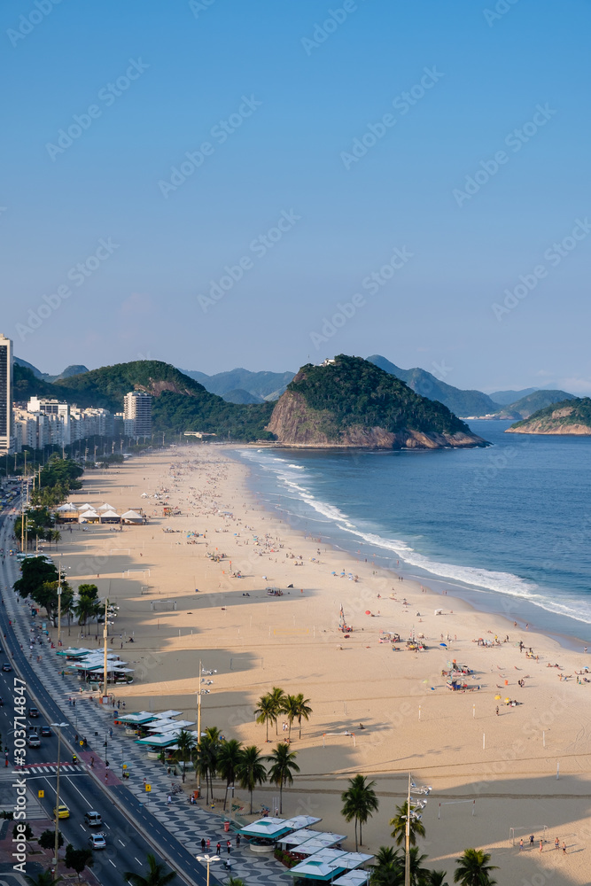 Φωτογραφία view of Copacabana and Leme beach during late afternoon, taken from the rooftop of a hotel, some shadows can be seen on the beach