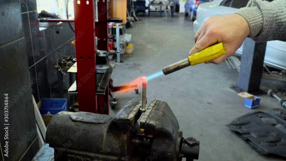 Fire of gas burner heats up red-hot the metal bolt Fire of gas burner heats up red-hot the metal bolt