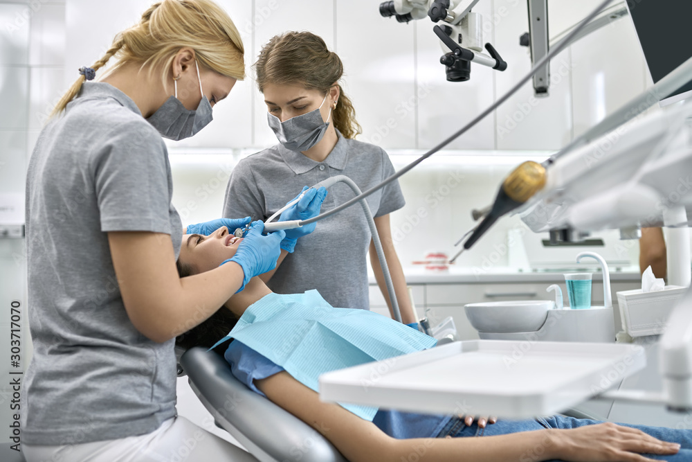 Pretty woman's teeth treatment in dental clinic Pretty woman's teeth treatment in dental clinic