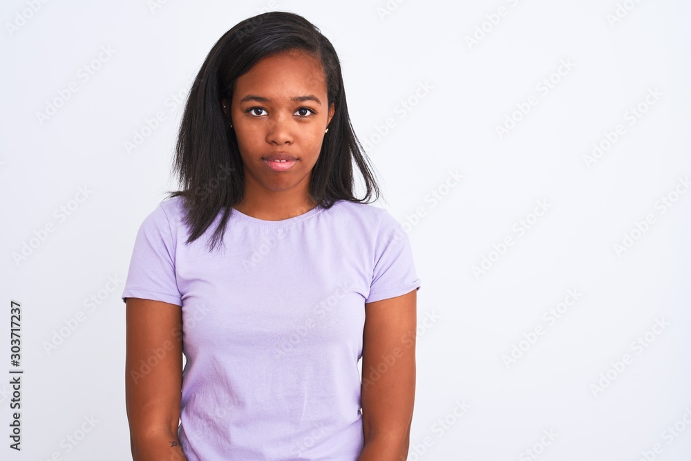 Beautiful young african american woman over isolated background with serious expression on face. Simple and natural looking at the camera. Beautiful young african american woman over isolated background with serious expression on face. Simple and natural looking at the camera.