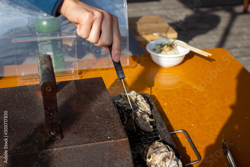 牡蠣が焼けているか確認（牡蠣小屋） checking an oyster if ready  photo