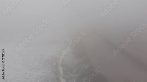 Aerials on beach on extrememly foggy day. photo