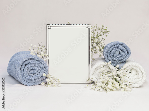 Natural cosmetics SPA mock-up on white background with flowers and soft towels. Organic cosmetic packaging Cardboard Box