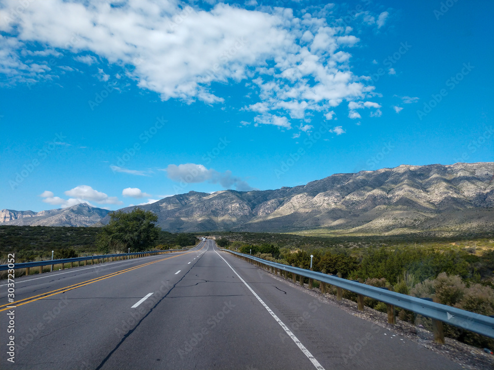 Asphalt road in the mountains with soft sky on the background. Asphalt road in the mountains with soft sky on the background.