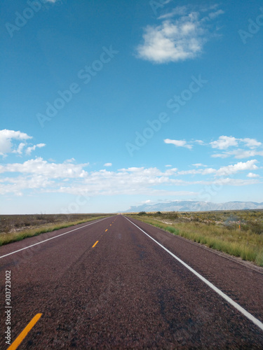 Asphalt road in the mountains with soft sky on the background. © wayker