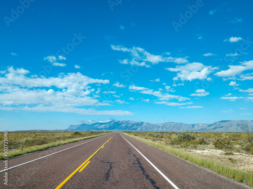 Asphalt road in the mountains with soft sky on the background. © wayker