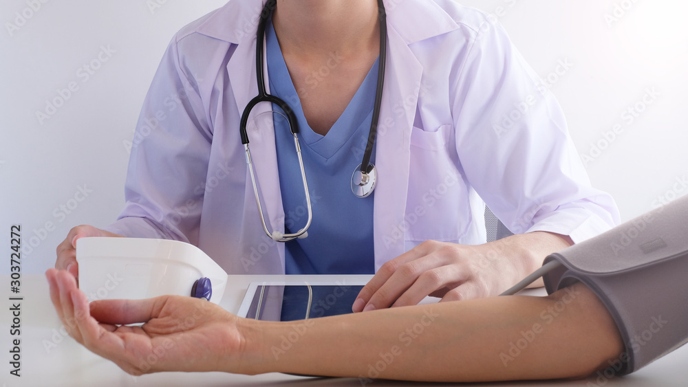 doctor checking patient blood pressure for medical check up. doctor checking patient blood pressure for medical check up.