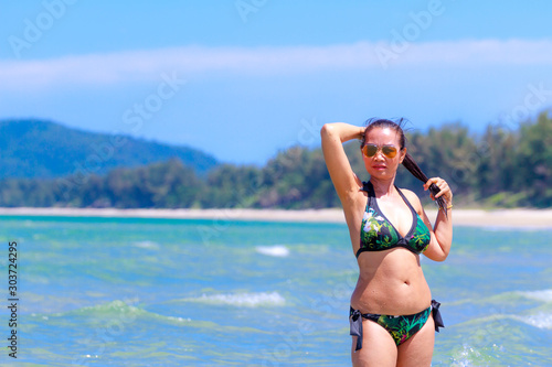 Woman shape huge with bikini and sunshine on beach