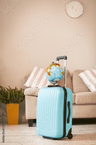 Blue suitcase with globe on it. photo