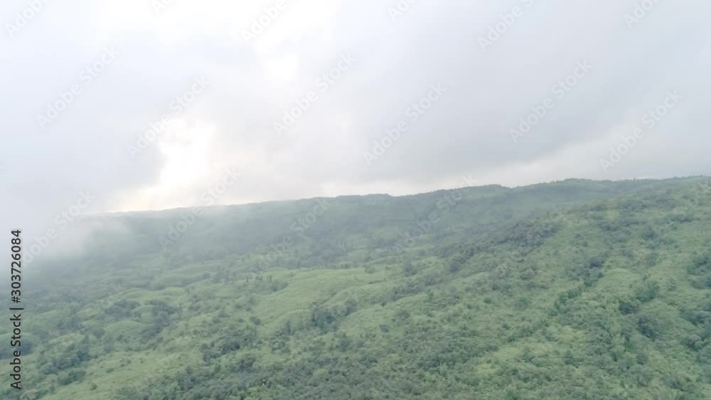 Clouds over the top of mountains and hills, forecasting heavy rains over tropical forest Clouds over the top of mountains and hills, forecasting heavy rains over tropical forest