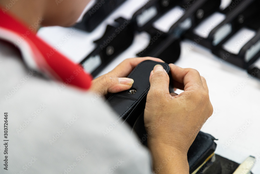 Designer checking quality leather for make camera case
