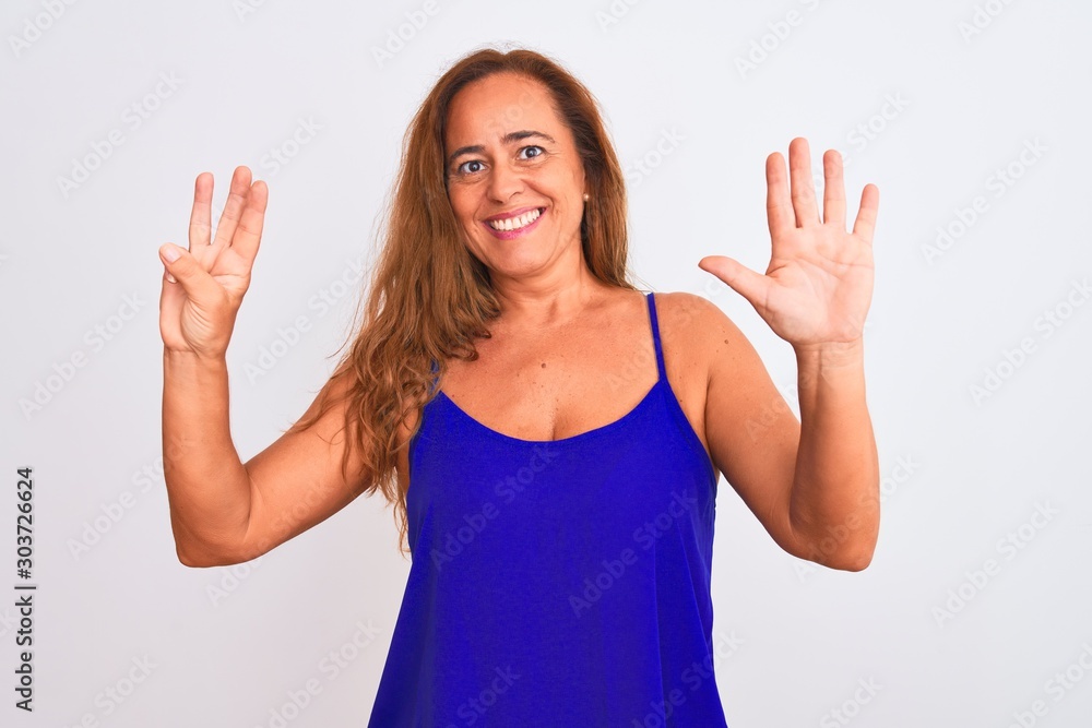 Middle age mature woman standing over white isolated background showing and pointing up with fingers number eight while smiling confident and happy. Middle age mature woman standing over white isolated background showing and pointing up with fingers number eight while smiling confident and happy.
