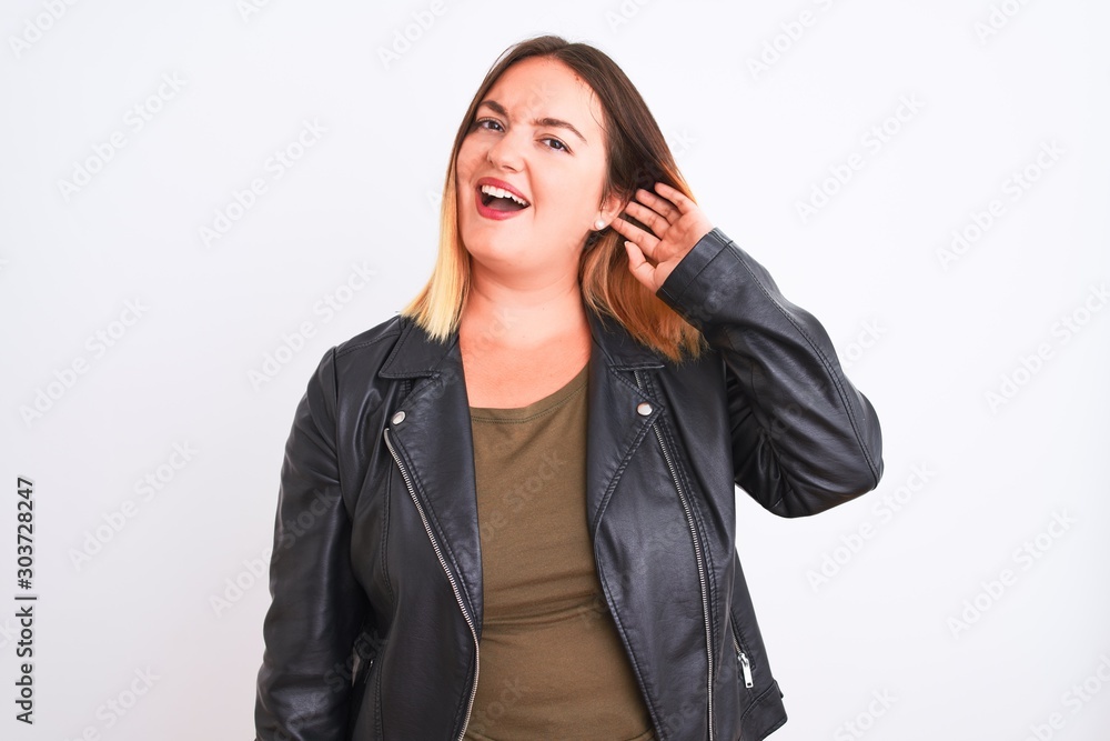 Young beautiful woman wearing t-shirt and jacket standing over isolated white background smiling with hand over ear listening an hearing to rumor or gossip. Deafness concept. Young beautiful woman wearing t-shirt and jacket standing over isolated white background smiling with hand over ear listening an hearing to rumor or gossip. Deafness concept.