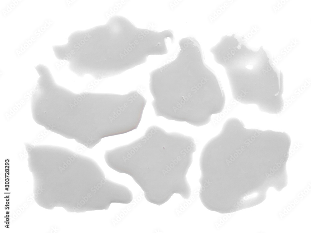 Fototapeta premium Spilled milk puddle isolated on white background. Texture of spilled milk. Milk on white background.