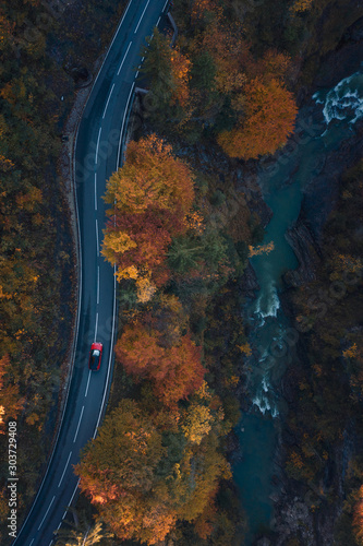 Aerial view of a car driving through an autumn forest, Salzburg, Austria  photo