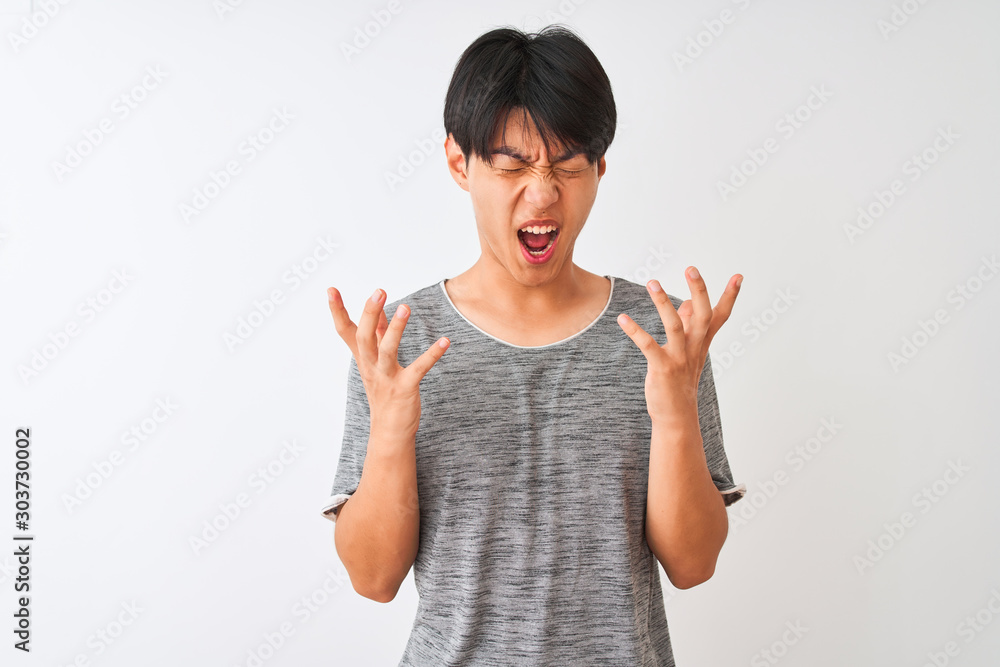 Φωτογραφία Young chinese man wearing casual t-shirt standing over isolated white background celebrating mad and crazy for success with arms raised and closed eyes screaming excited