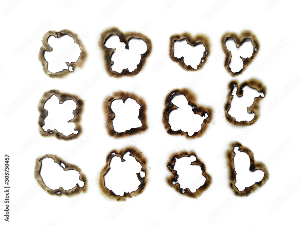 Collection of burnt holes in a piece of paper isolated on white background. Fire holes in white paper.
