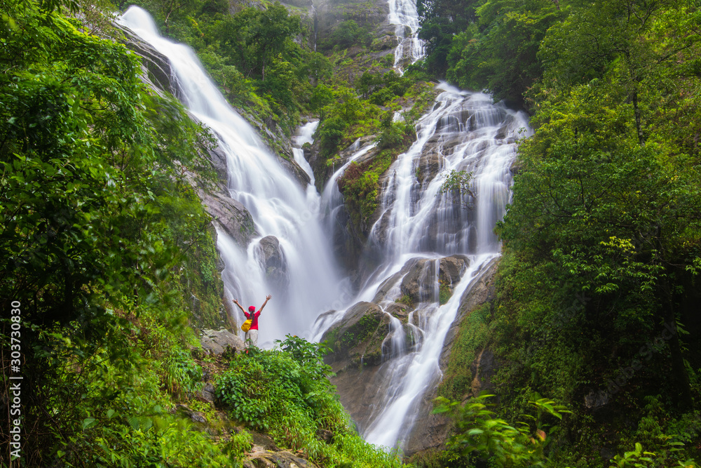 Young girl  hiking  on Pi-tu-gro waterfall, Beautiful waterfall in Tak  province, ThaiLand.