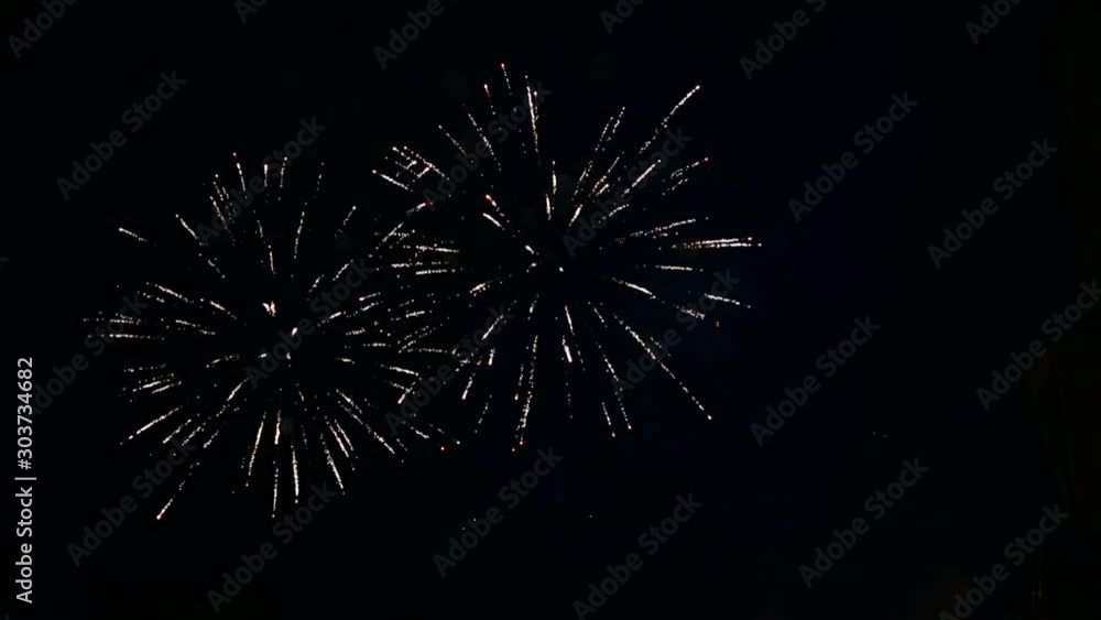 Glittering sparks of festive salute in the night sky Glittering sparks of festive salute in the night sky
