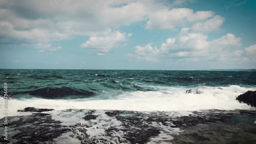 Waves hitting the shore on cloudy summer day Waves hitting the shore on cloudy summer day