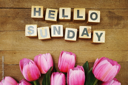 Hello Sunday alphabet letters on wooden background