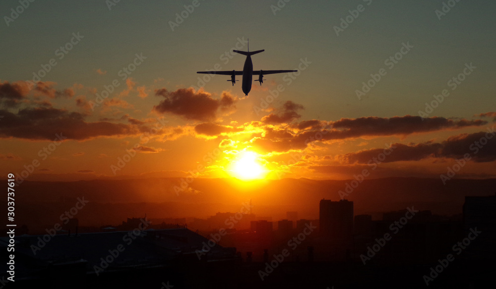 The plane flies low over the city during sunset. The plane flies off into the sunset. The plane flies low over the city during sunset. The plane flies off into the sunset.